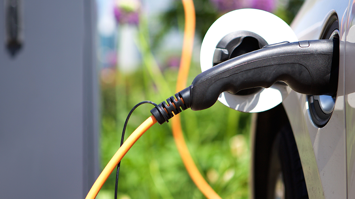 Image of an EV plugged in.
